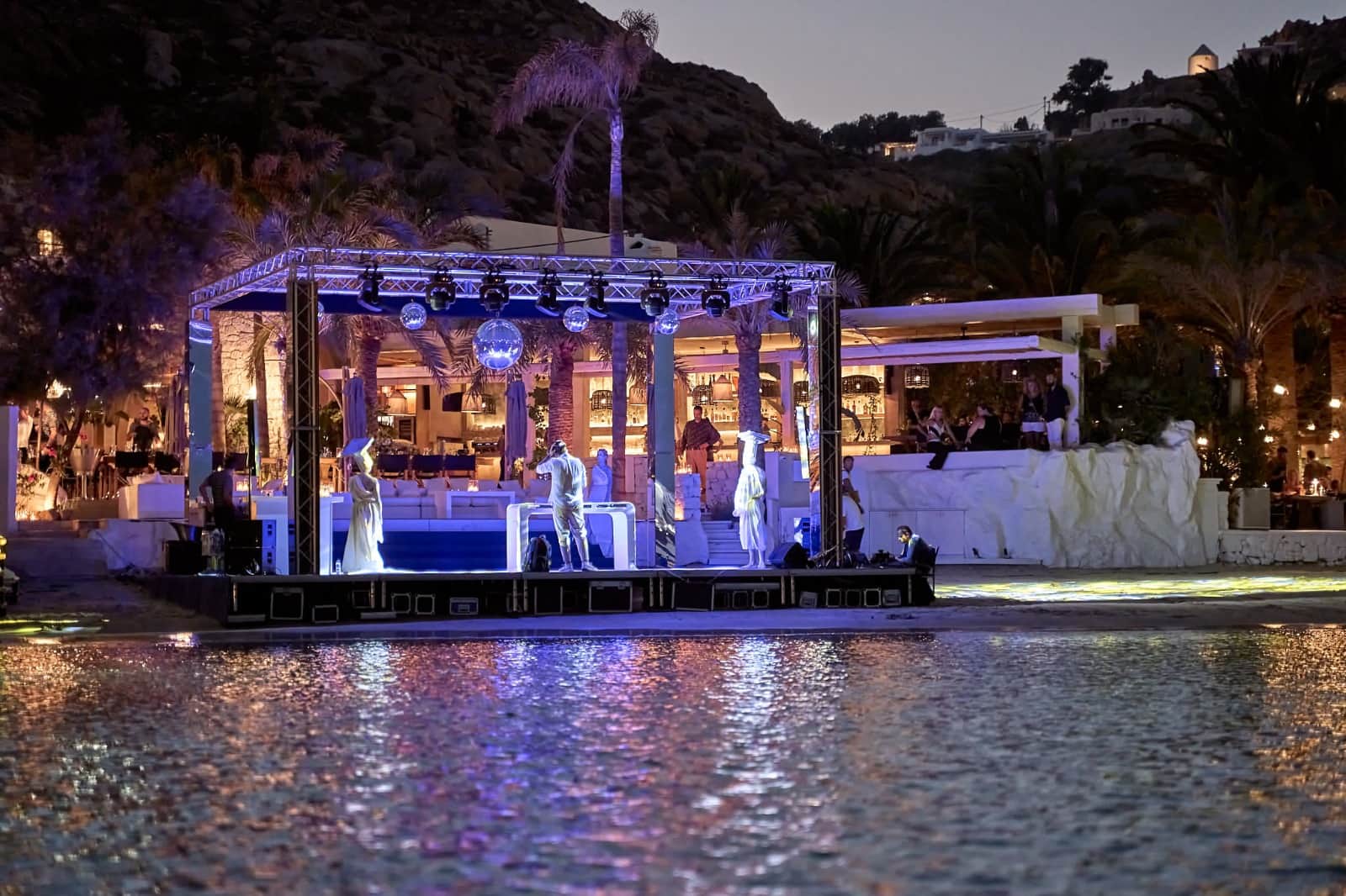 Illuminated waterfront pavilion at a private evening event in Mykonos